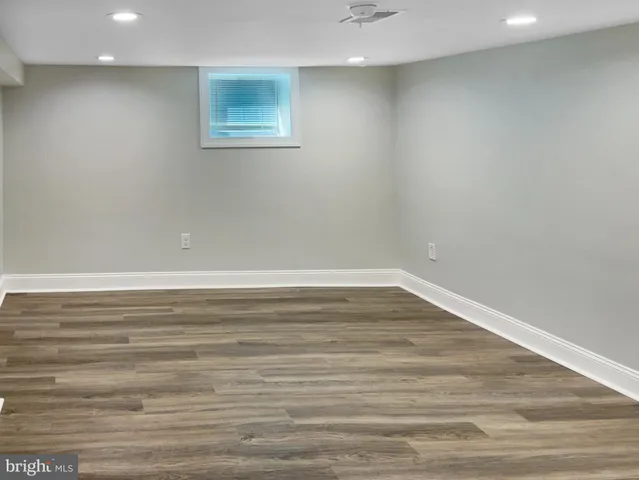 a view of a room with wooden floor and white walls