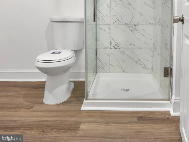 a bathroom with a toilet and a shower