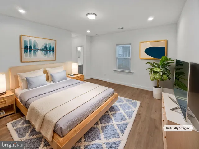 a bedroom with bed and painting on the wall