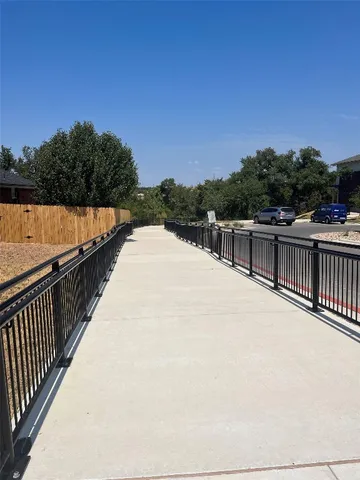 a kitchen with granite countertop a refrigerator a stove and a sink