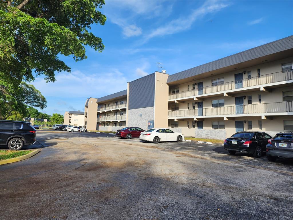 8020 Fairview Drive, Unit 109 Tamarac, FL 33321 - Photo 11 of 12 a view of a cars parked in front of a building