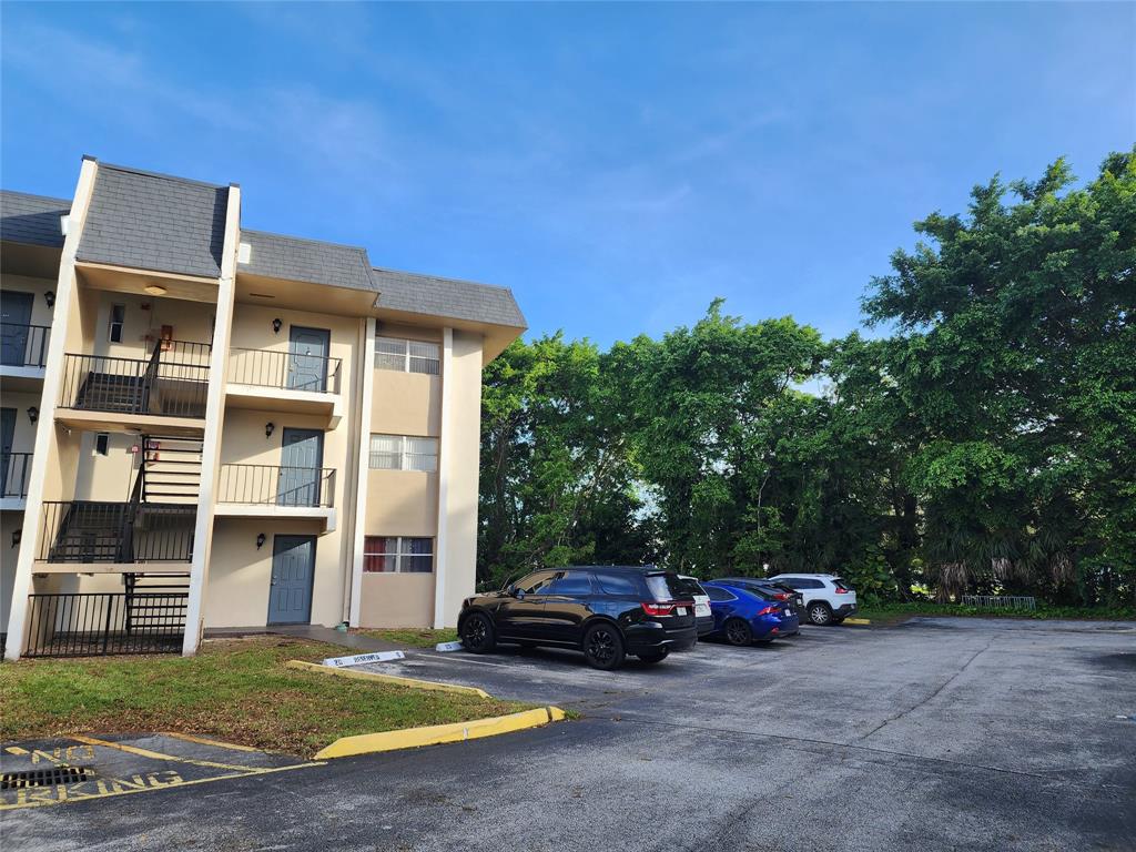 8020 Fairview Drive, Unit 109 Tamarac, FL 33321 - Photo 12 of 12 a view of street and car parked in front of house