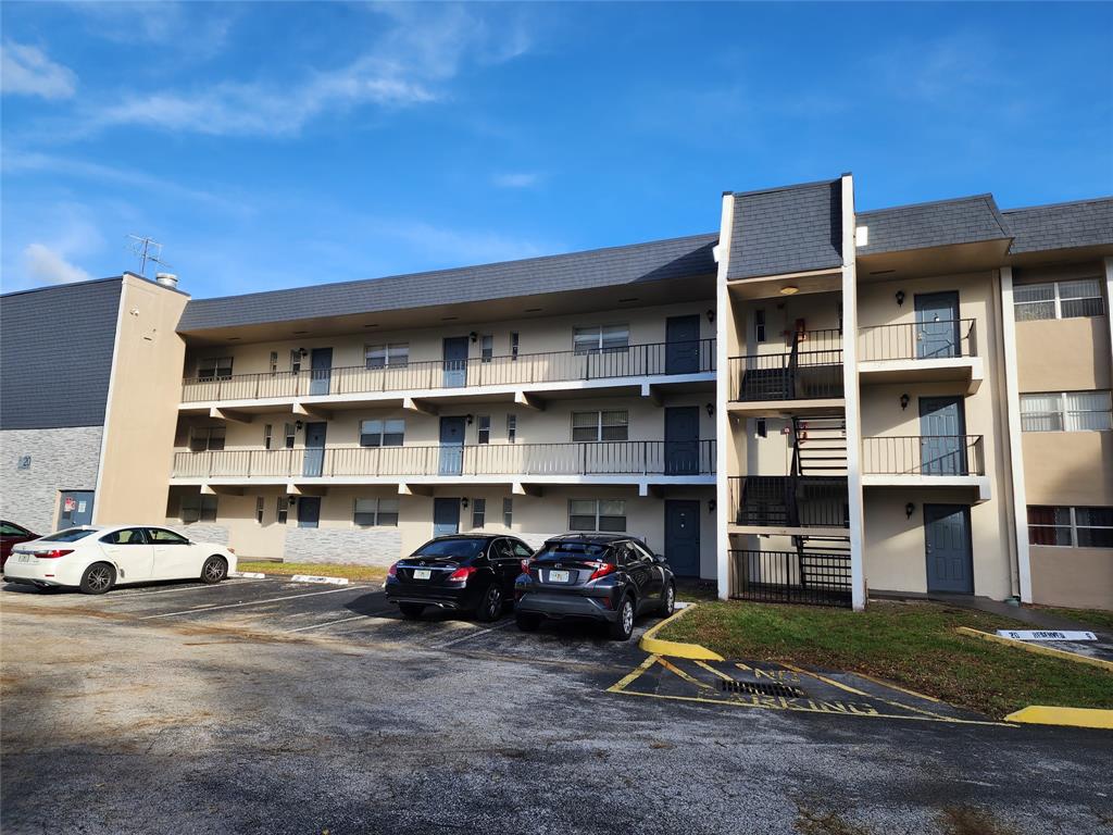 8020 Fairview Drive, Unit 109 Tamarac, FL 33321 - Photo 2 of 12 a car parked in front of a house