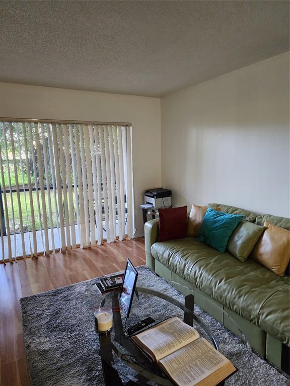 8020 Fairview Drive, Unit 109 Tamarac, FL 33321 - Photo 3 of 12 a living room with furniture and a window
