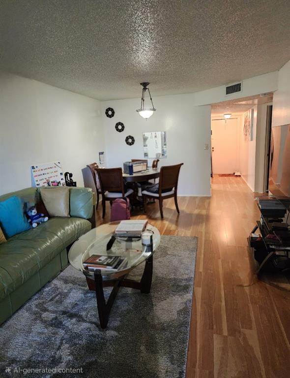 8020 Fairview Drive, Unit 109 Tamarac, FL 33321 - Photo 5 of 12 a living room with furniture and wooden floor