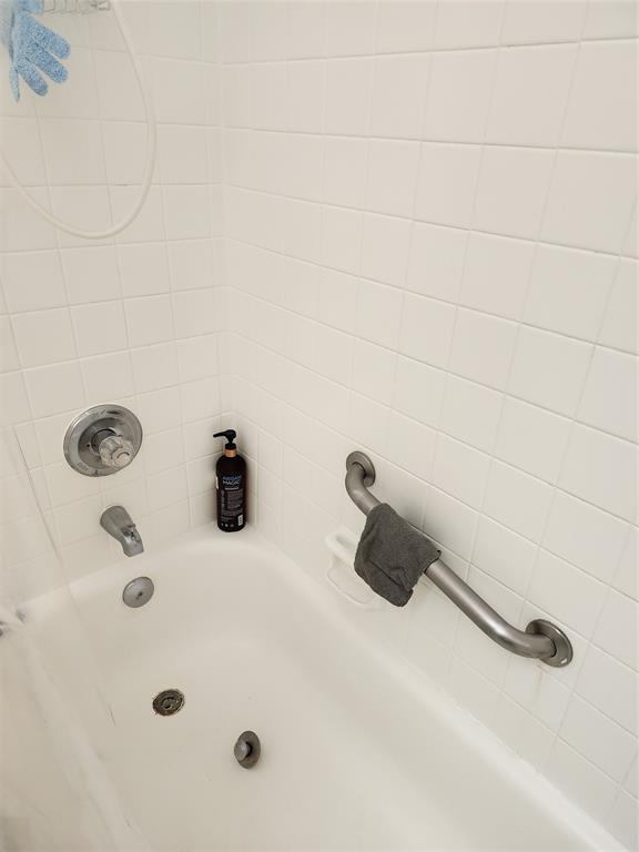 8020 Fairview Drive, Unit 109 Tamarac, FL 33321 - Photo 8 of 12 a bathroom with a tub