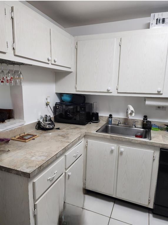 8020 Fairview Drive, Unit 109 Tamarac, FL 33321 - Photo 10 of 12 a kitchen with granite countertop white cabinets and a sink