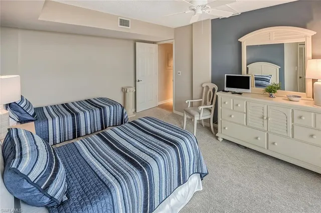 a bedroom with two beds and a large window