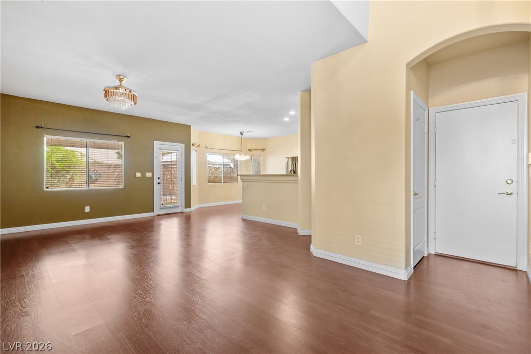 8934 Deep Ridge Court Las Vegas, NV 89178 - Photo 3 of 47 Rich hardwood-style flooring extends through this airy, sun-kissed living space with ample natural light.