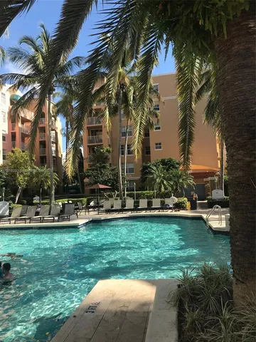a front view of a house with swimming pool and green space