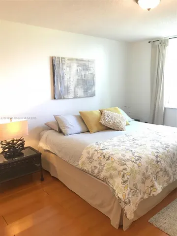 a bedroom with a bed and a night stand