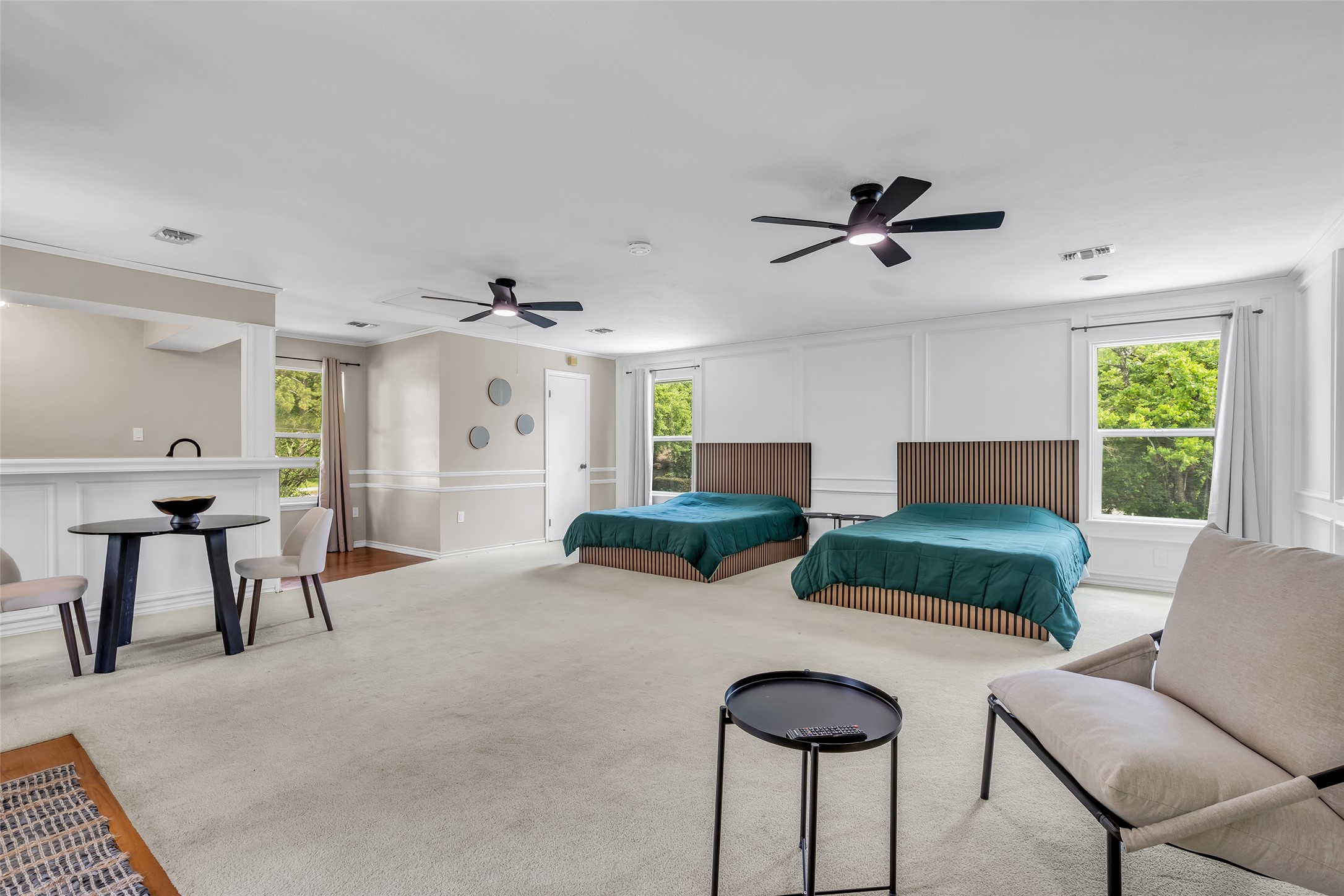 22502 Fields Lane Spring, TX 77389 - Photo 27 of 39 This spacious apartment features two beds, modern ceiling fans, and large windows that provide ample natural light. The room's neutral color palette and clean lines offer a contemporary feel.