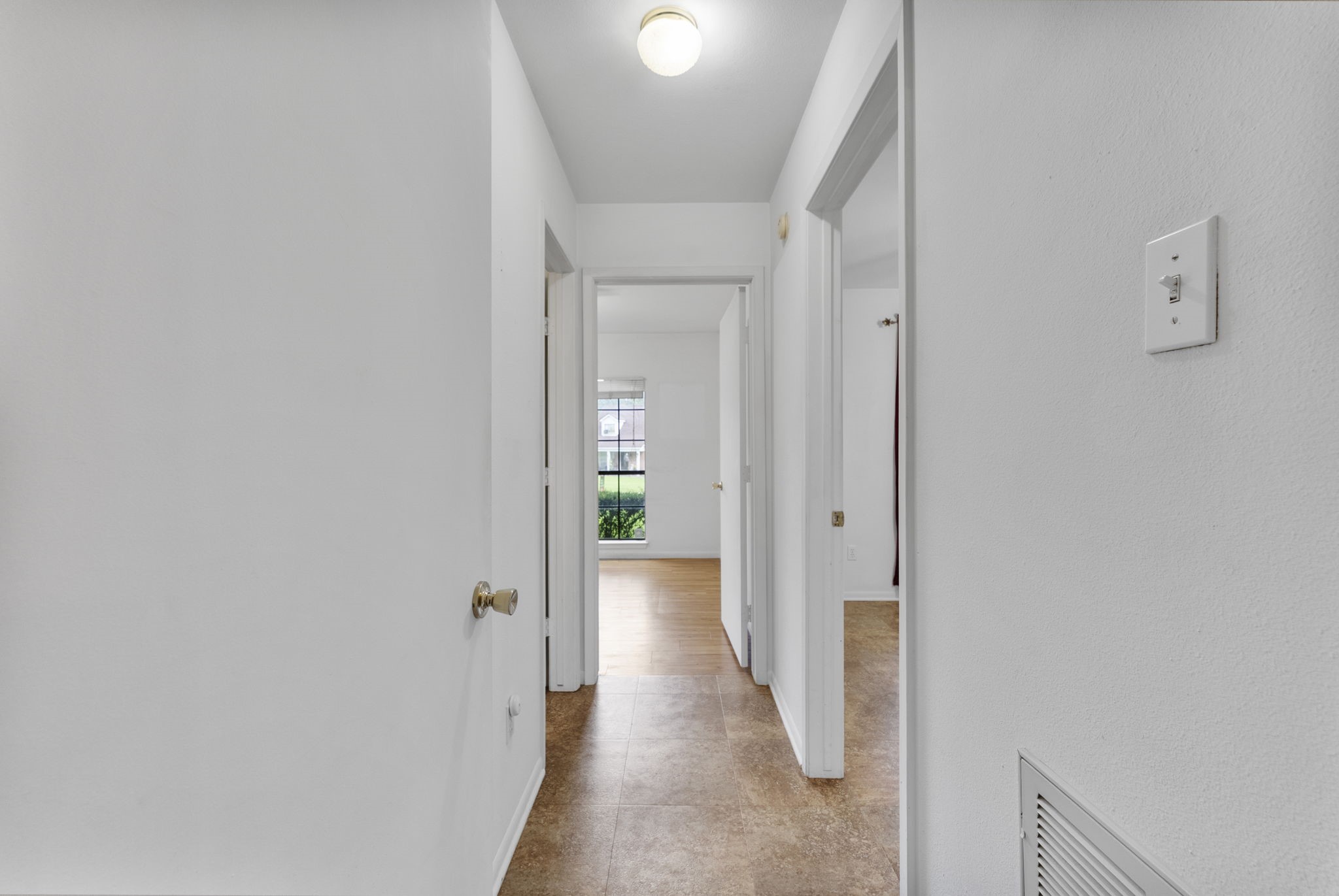 202 Sunset Boulevard Conroe, TX 77303 - Photo 25 of 50 Discover a welcoming hallway leading to a bright guest bedrooms, inviting comfort and warmth.
