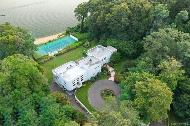 an aerial view of a house with outdoor space and lake view