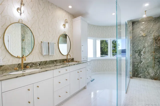 a bathroom with a granite countertop double vanity sink and a mirror