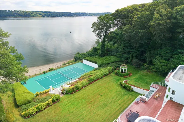 an aerial view of a house with a yard and lake view