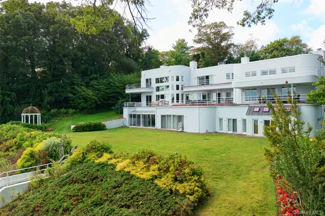 an aerial view of residential houses with outdoor space and trees