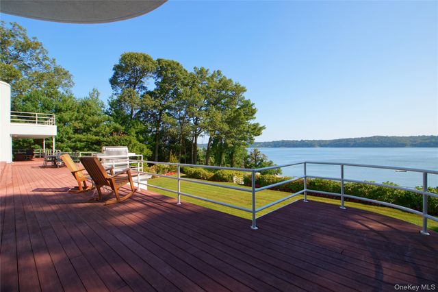 a living room with furniture large window and flat screen tv