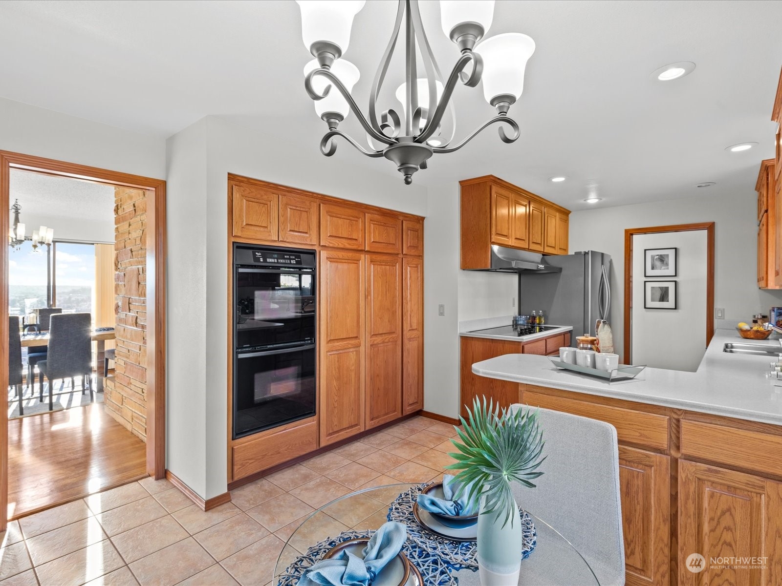 801 Grant Avenue South Renton, WA 98057 - Photo 16 of 40 a dining room with stainless steel appliances kitchen island granite countertop a table and chairs in it