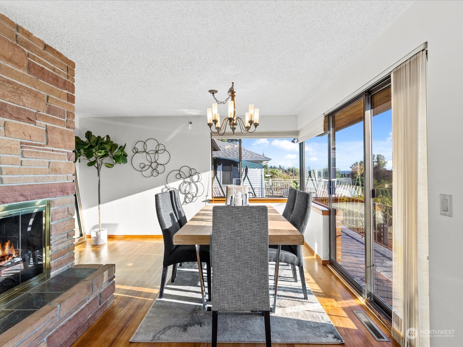 801 Grant Avenue South Renton, WA 98057 - Photo 10 of 40 a view of a dining room with furniture a chandelier and wooden floor