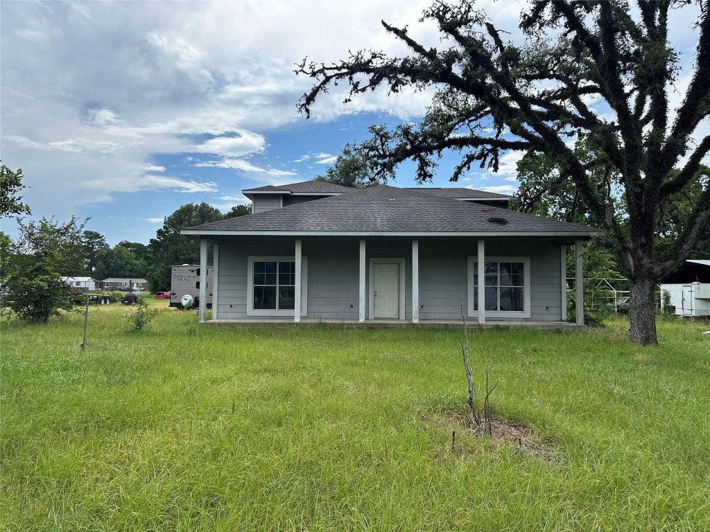 7700 Farm To Market 1010 Road Cleveland, TX 77327 - Photo 2 of 9 a front view of a house with a garden