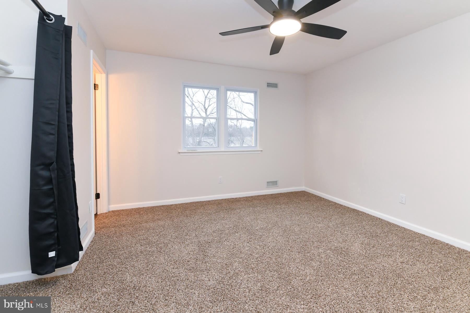 10 Ivy Lane Sicklerville, NJ 08081 - Photo 17 of 30 an empty room with ceiling fan and window