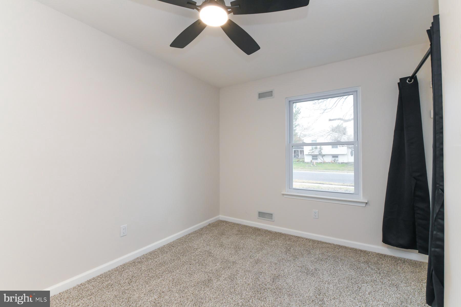10 Ivy Lane Sicklerville, NJ 08081 - Photo 19 of 30 an empty room with a window and a fan