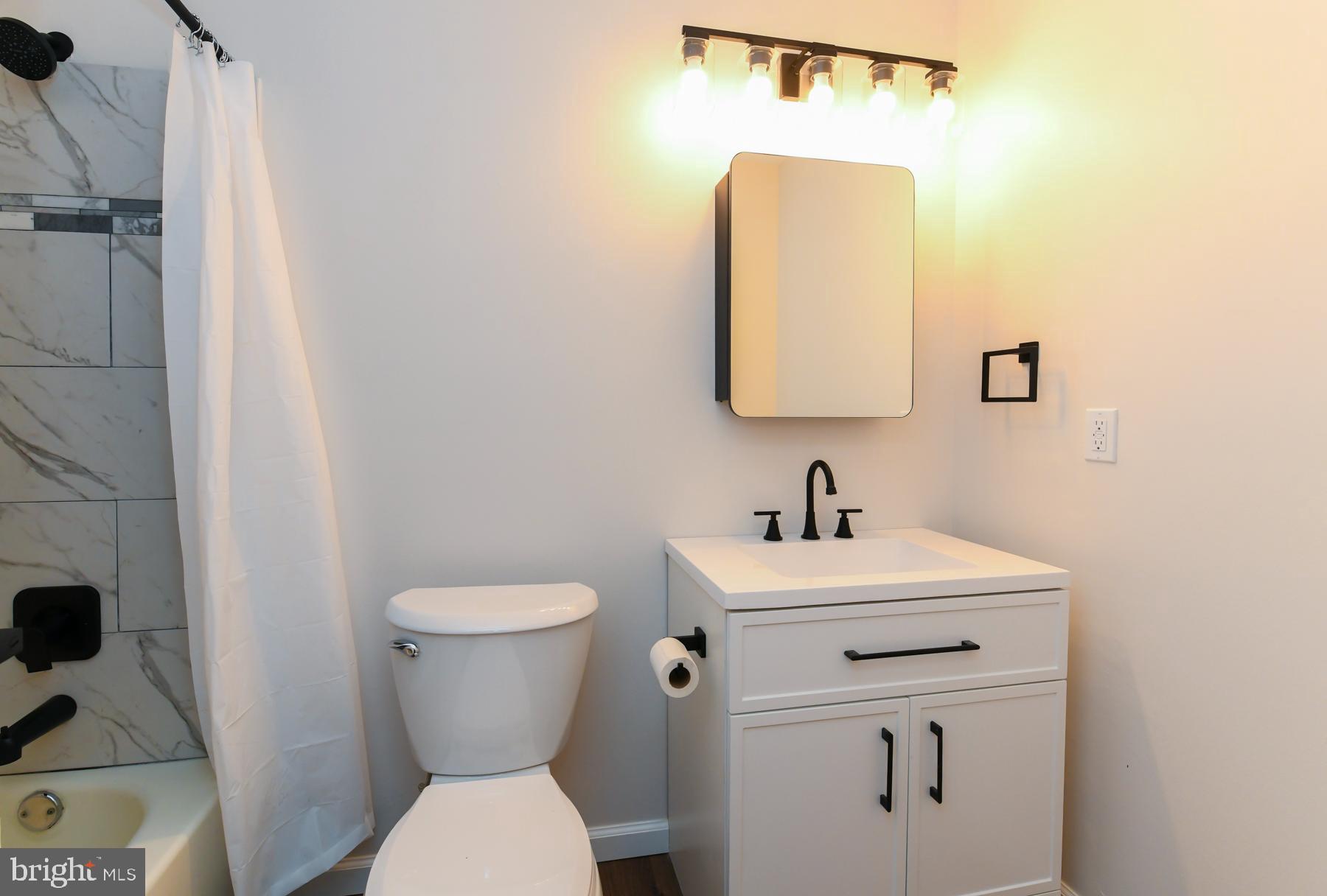 10 Ivy Lane Sicklerville, NJ 08081 - Photo 22 of 30 a bathroom with a toilet sink and mirror
