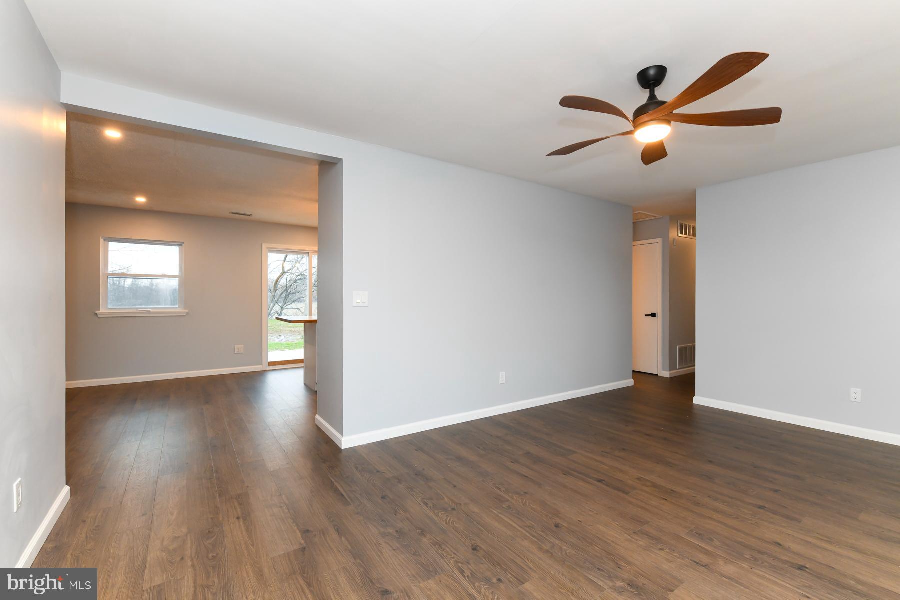 10 Ivy Lane Sicklerville, NJ 08081 - Photo 9 of 30 a view of an empty room with wooden floor and a ceiling fan