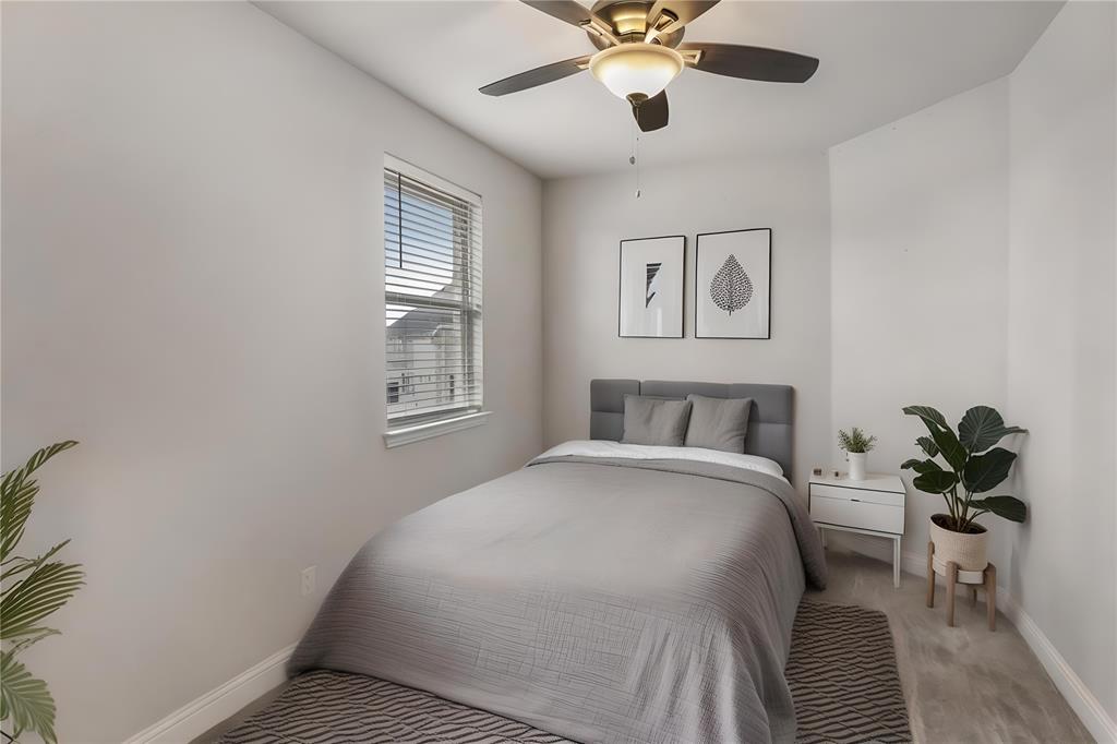 6201 Cupleaf Road Flower Mound, TX 76226 - Photo 17 of 40 a bedroom with a large bed and a chandelier