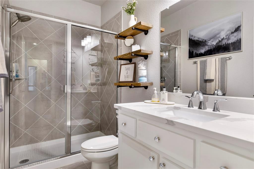 6201 Cupleaf Road Flower Mound, TX 76226 - Photo 18 of 40 a bathroom with a sink a toilet and shower