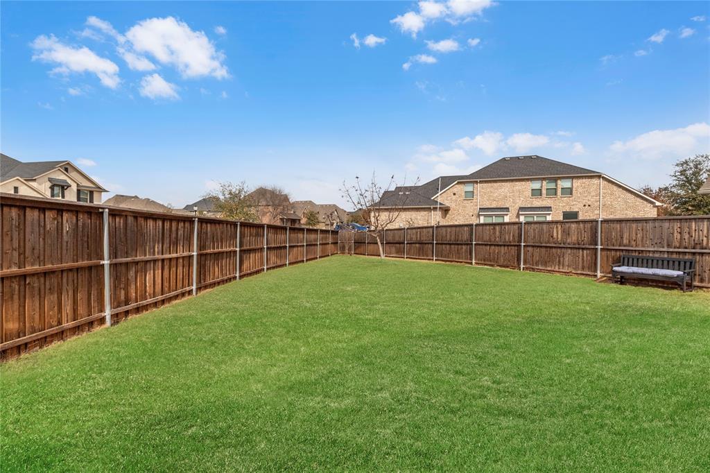 6201 Cupleaf Road Flower Mound, TX 76226 - Photo 26 of 40 a view of a backyard with a garden and deck