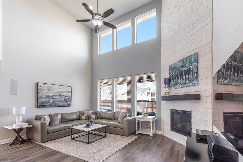 6201 Cupleaf Road Flower Mound, TX 76226 - Photo 3 of 40 a living room with furniture a fireplace and a large window