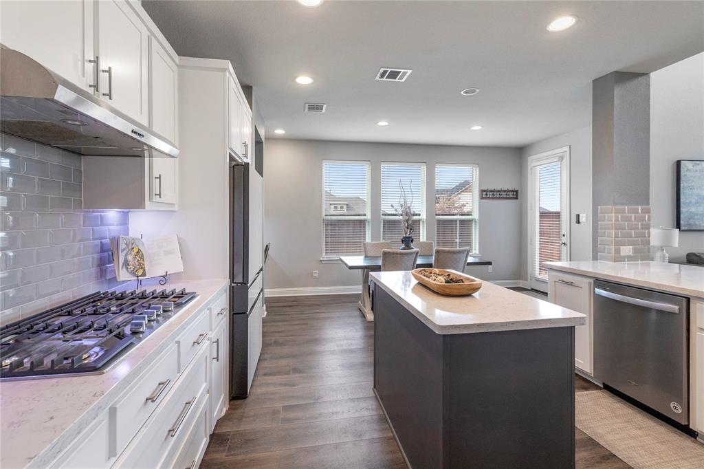 6201 Cupleaf Road Flower Mound, TX 76226 - Photo 5 of 40 a kitchen with kitchen island stainless steel appliances a sink stove and cabinets