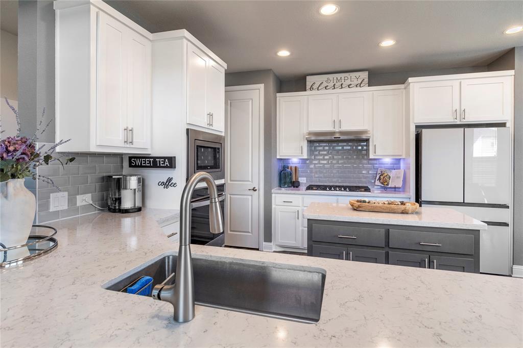 6201 Cupleaf Road Flower Mound, TX 76226 - Photo 6 of 40 a kitchen with kitchen island sink cabinets and refrigerator