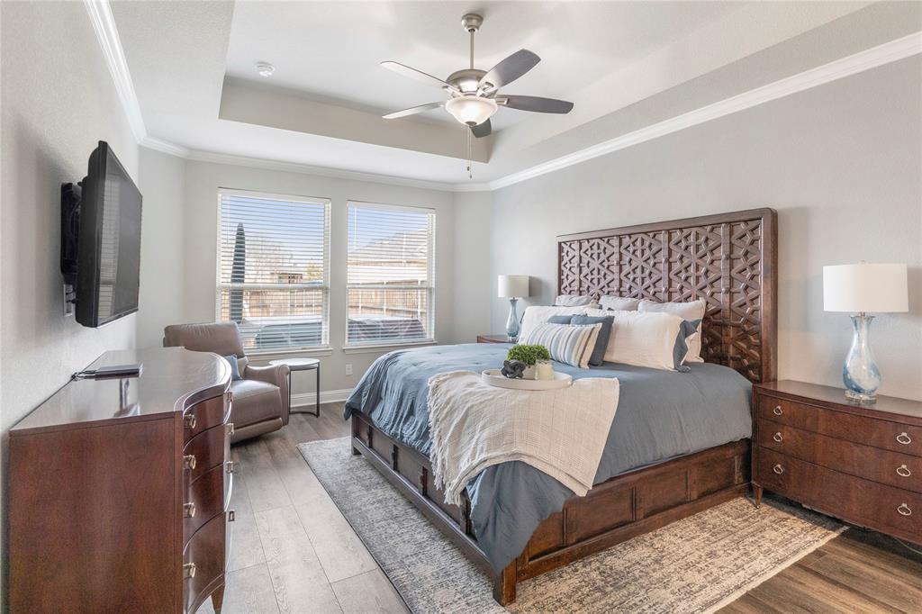 6201 Cupleaf Road Flower Mound, TX 76226 - Photo 9 of 40 a bedroom with a large bed and a flat tv screen