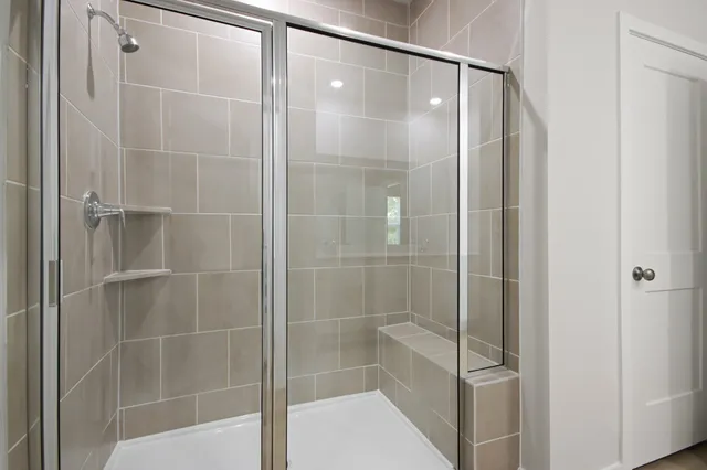 a bathroom with a glass shower door