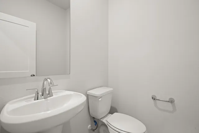 a white toilet sitting next to a bathroom sink