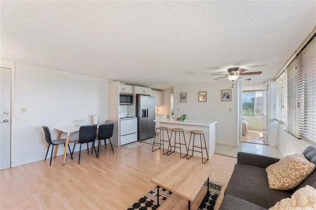 a dining room with furniture a rug and wooden floor