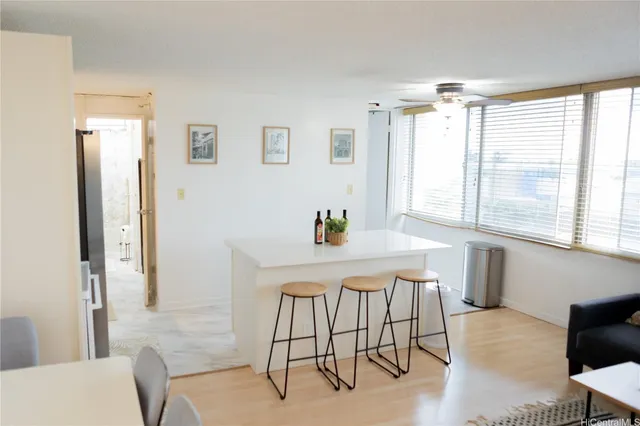 a kitchen with stainless steel appliances a refrigerator a microwave a stove and white cabinets