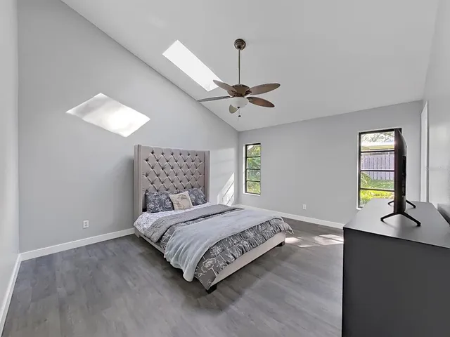 a bedroom with a bed window and a table