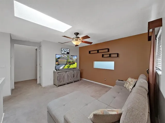 a view of a livingroom with furniture and ceiling fan