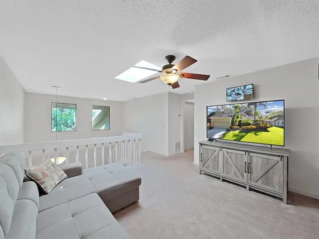 a work room with furniture and a ceiling fan