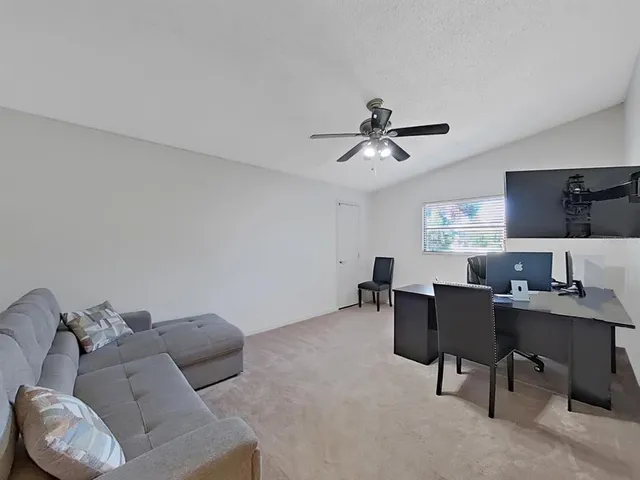 a dining room with furniture and a floor to ceiling window