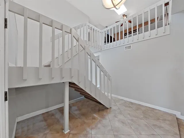 a view of staircase with white walls and a window