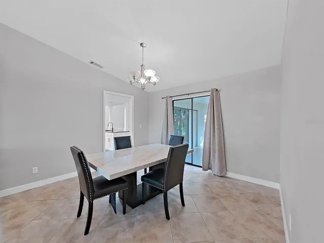 a view of a dining room with furniture and window