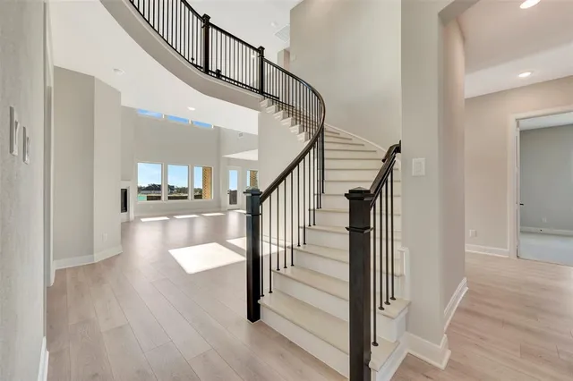 a view of entryway and hall with wooden floor