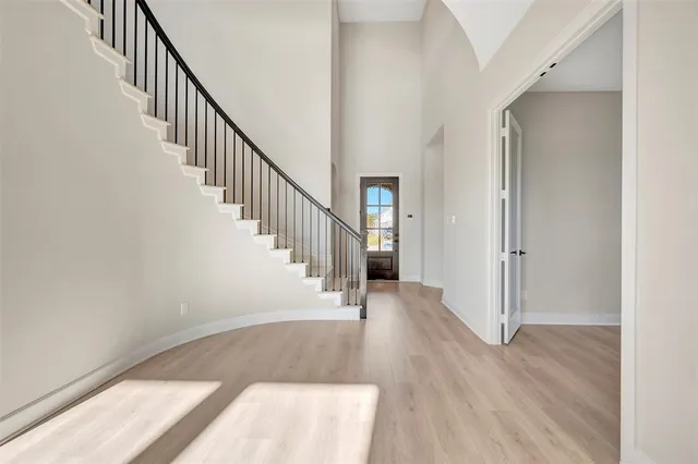 a view of staircase with wooden floor and a rug