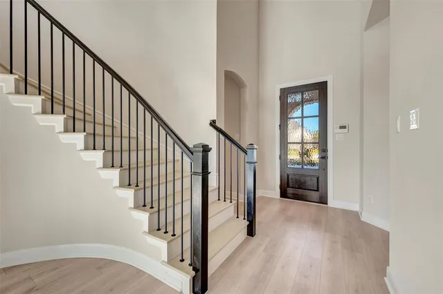 an empty room with window and ceiling fan