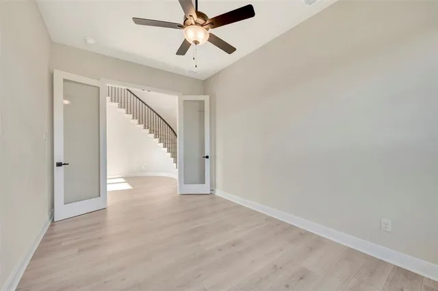 a view of a hallway with wooden floor and closet